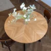 FJÄRIL LUMI round oak dining table Handmade Fjäril Lumi table in a serene interior with natural textures