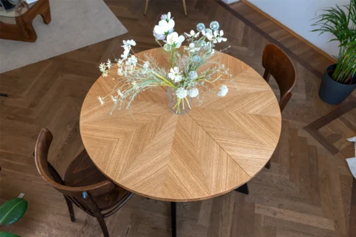 FJÄRIL LUMI round oak dining table Handmade Fjäril Lumi table in a serene interior with natural textures